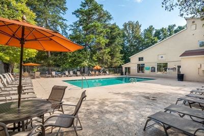 Outdoor swimming pool with cabanas and chairs